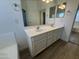 Bathroom with double sink vanity, white cabinets, and chrome fixtures at 29900 N Maravilla Dr, San Tan Valley, AZ 85143