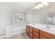 Bathroom featuring double sinks, a vanity, and a combined tub and shower at 29900 N Maravilla Dr, San Tan Valley, AZ 85143