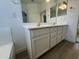 Bathroom featuring a double sink vanity with white cabinets and wood look floors at 29900 N Maravilla Dr, San Tan Valley, AZ 85143