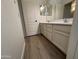 Bathroom featuring a double sink vanity, white cabinets, and vinyl flooring at 29900 N Maravilla Dr, San Tan Valley, AZ 85143