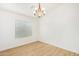 Dining room features a modern chandelier, neutral walls and wood floors at 29900 N Maravilla Dr, San Tan Valley, AZ 85143