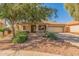 Single-story home featuring a well-manicured front yard, tile roof, and covered porch at 29900 N Maravilla Dr, San Tan Valley, AZ 85143