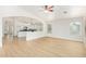 Bright living room showcasing wood floors and an open floor plan connecting to the kitchen at 29900 N Maravilla Dr, San Tan Valley, AZ 85143