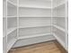 Spacious walk-in pantry featuring ample shelving for organized storage at 29900 N Maravilla Dr, San Tan Valley, AZ 85143