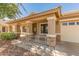 Charming front porch with stone accents and a decorative railing, offering curb appeal at 29900 N Maravilla Dr, San Tan Valley, AZ 85143