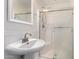 Clean and well-lit bathroom featuring a pedestal sink and a glass-enclosed shower at 3110 E Desert Flower Ln, Phoenix, AZ 85048