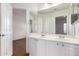 Bright bathroom featuring a double vanity with white cabinetry and modern fixtures at 3110 E Desert Flower Ln, Phoenix, AZ 85048