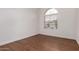 Bedroom featuring hardwood floors and a window with white blinds at 3110 E Desert Flower Ln, Phoenix, AZ 85048