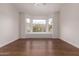 Bright bedroom featuring a bay window with scenic views and hardwood floors at 3110 E Desert Flower Ln, Phoenix, AZ 85048