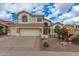 Stately home with a large driveway, three-car garage, and arched entryway at 3110 E Desert Flower Ln, Phoenix, AZ 85048