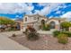 Beautiful two-story home with a well-manicured front yard and desert landscaping at 3110 E Desert Flower Ln, Phoenix, AZ 85048