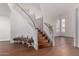 Elegant foyer with a curved staircase, hardwood floors, and natural light at 3110 E Desert Flower Ln, Phoenix, AZ 85048