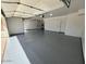 Garage with a gray epoxy floor and white walls at 3110 E Desert Flower Ln, Phoenix, AZ 85048