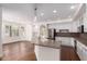 Bright, open kitchen featuring white cabinets, stainless steel appliances, and an eat-in island at 3110 E Desert Flower Ln, Phoenix, AZ 85048