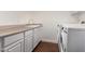 Laundry room featuring cabinets, a sink and a modern washer and dryer at 3110 E Desert Flower Ln, Phoenix, AZ 85048