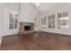 Bright living room featuring a stone fireplace and plantation shutters at 3110 E Desert Flower Ln, Phoenix, AZ 85048