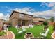 Lush backyard boasting artificial turf, fire pit area, and comfortable seating perfect for gatherings and relaxation at 3126 W Apollo Rd, Phoenix, AZ 85041