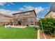 Two-story home backyard with a pergola, artificial grass, and playset for outdoor enjoyment at 3126 W Apollo Rd, Phoenix, AZ 85041