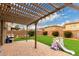 Charming backyard featuring a shaded pergola, playset, and low-maintenance artificial grass at 3126 W Apollo Rd, Phoenix, AZ 85041