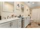 Bright bathroom featuring double sinks, modern fixtures, and a framed mirror for a luxurious feel at 3126 W Apollo Rd, Phoenix, AZ 85041