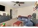 Bright bedroom boasting carpeted floors, a ceiling fan, and an open layout to welcome relaxation at 3126 W Apollo Rd, Phoenix, AZ 85041