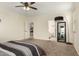 Spacious bedroom featuring neutral walls, carpet flooring, ceiling fan, and ample natural light at 3126 W Apollo Rd, Phoenix, AZ 85041