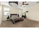 Bright bedroom with carpet, ceiling fan, a large bed and a vanity in a well-lit space at 3126 W Apollo Rd, Phoenix, AZ 85041