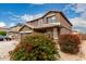 View of the house with decorative bushes with red flowers at 3126 W Apollo Rd, Phoenix, AZ 85041