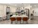 Well-lit kitchen features a large center island with quartz countertops and stainless steel appliances at 3126 W Apollo Rd, Phoenix, AZ 85041