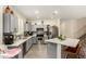 Bright kitchen showcasing stainless steel appliances, gray cabinetry, and quartz countertops at 3126 W Apollo Rd, Phoenix, AZ 85041