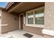 Covered front porch with a welcome sign, large windows, and a decorative light fixture at 3126 W Apollo Rd, Phoenix, AZ 85041