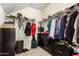 Walk-in closet featuring custom organizers and a variety of clothing and accessories at 3126 W Apollo Rd, Phoenix, AZ 85041