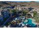 Aerial view showcases the community pool area, surrounded by lush greenery and beautiful desert landscape at 3236 E Chandler Blvd # 2057, Phoenix, AZ 85048