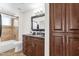 Bathroom features a dark wood vanity, granite counters, and tiled shower at 3236 E Chandler Blvd # 2057, Phoenix, AZ 85048