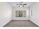 Neutral bedroom featuring a ceiling fan and large window with outside views at 3236 E Chandler Blvd # 2057, Phoenix, AZ 85048