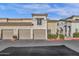 Close up of a condo building with two-car garage and desert landscaping at 3236 E Chandler Blvd # 2057, Phoenix, AZ 85048