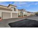 Street view of an apartment complex with individual garages and desert landscaping at 3236 E Chandler Blvd # 2057, Phoenix, AZ 85048