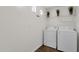 Bright laundry room with washer, dryer, shelving, and tile flooring at 3236 E Chandler Blvd # 2057, Phoenix, AZ 85048