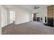 Bright living room with carpet, fireplace, and sliding door to a balcony with mountain views at 3236 E Chandler Blvd # 2057, Phoenix, AZ 85048