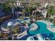 Aerial view of a community pool area features lush landscaping, poolside seating, and a relaxing spa at 3236 E Chandler Blvd # 2057, Phoenix, AZ 85048