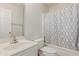 Well-lit bathroom features a tub with shower, curtain, and a single sink vanity at 3363 W Lone Cactus Dr, Phoenix, AZ 85027