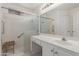 Bright bathroom with vanity and walk-in shower with built-in bench and safety bar at 3363 W Lone Cactus Dr, Phoenix, AZ 85027
