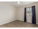 This bedroom has vinyl floors, ceiling fan, and a window with blue curtains at 3363 W Lone Cactus Dr, Phoenix, AZ 85027