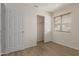 Bedroom featuring wood look floors, closet and window with window blinds at 3363 W Lone Cactus Dr, Phoenix, AZ 85027