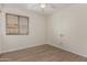 A comfortable bedroom with wood-look floors, a ceiling fan and window with blinds at 3363 W Lone Cactus Dr, Phoenix, AZ 85027
