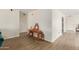 Bright foyer area with light wood floors, neutral paint, and an elegant table with decorative items at 3363 W Lone Cactus Dr, Phoenix, AZ 85027