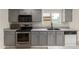 Updated kitchen with gray cabinets, stainless steel appliances, and a stylish backsplash at 3363 W Lone Cactus Dr, Phoenix, AZ 85027