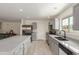 Bright kitchen with gray cabinets, stainless steel appliances, and a large island with countertop seating at 3363 W Lone Cactus Dr, Phoenix, AZ 85027