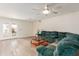 Bright and airy living room featuring wood floors, a green sofa, and a door leading to the outdoor space at 3363 W Lone Cactus Dr, Phoenix, AZ 85027