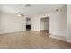 Spacious living room featuring wood floors, a ceiling fan, and neutral paint, offering a bright and airy atmosphere at 3363 W Lone Cactus Dr, Phoenix, AZ 85027